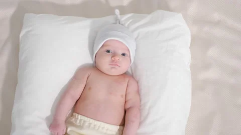 Cute baby lying on bed Stock Footage 98969457