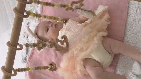 Cute baby lying on developing rug Видео 228787825