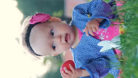 Cute baby playing with easter eggs on grass Vídeo Stock 264115413