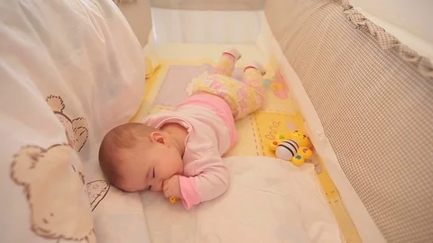 Cute baby playing with a pacifier in Stock Video Pond5 - Main Image