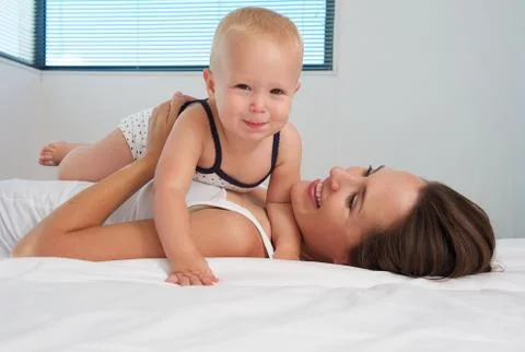 Cute baby together with happy young mother Stock Photos