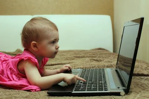 Cute baby working on computer Stock Photos