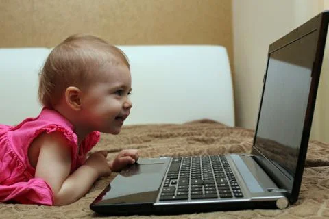 Cute baby working on computer Stock Photos