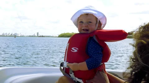 Cute baby's first time on a boat, 4K Stock Footage 50555785