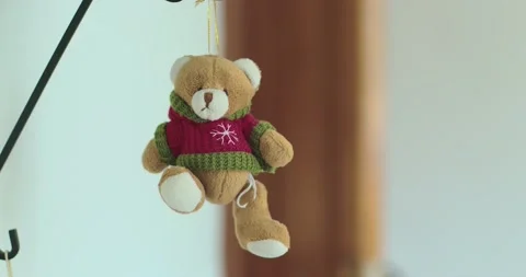 A cute bear toy hangs over the shelves. Stock Footage 166602977