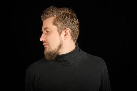 Cute bearded man, half-face portrait, black background Stock Photos