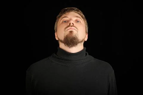 Cute bearded man, threw head back, black background Stock Photos