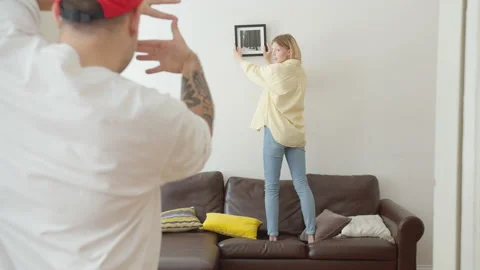 Cute beautiful and young couple of hipsters during home remodeling or moving new Video stock 134121353