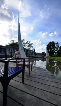 Cute Bench on small dock. Stock Photos