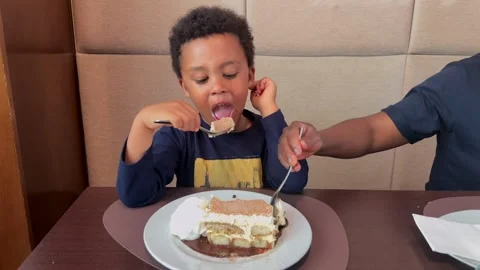 Cute Black Child, 5 y.o, Sharing an Italian Tiramisu Cake with his Young Black Stock Footage 308616718