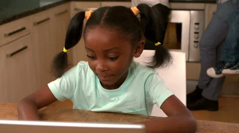 Cute black child using laptop in kitchen Stock Footage 57647384