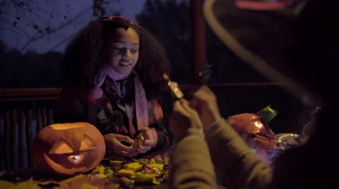 Cute black girl in devil mask frightening her friend on Halloween night Stock Footage 68986645