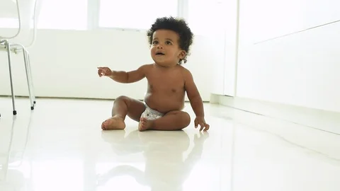 Cute black infant boy taking first steps 库存影片 89035650