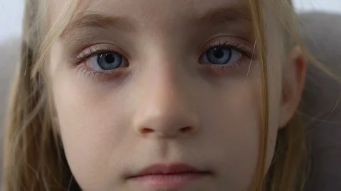 Cute blinking schoolgirl looking camera screwing up eyes, poor eyesight, health 動画素材 117220796