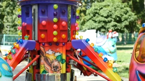 Cute blond 1,5 years old baby boy  on carousel slow motion Stock Footage 93314643