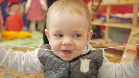 Cute blond boy two years playing in the children's educational center. The boy Stock Footage 75052241