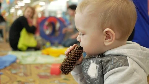 Cute blond boy two years playing in the children's educational center. The boy Video stock 75052334