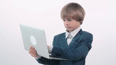 A cute blond boy works as a freelancer. The child is a businessman. Stock Footage 132372590