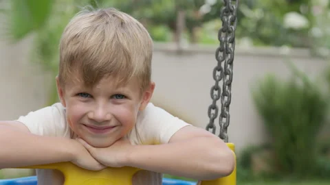Cute blonde boy without front teeth smiling and looking at camera Stock Footage 205360596