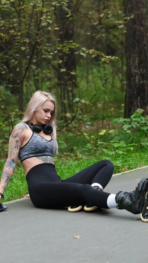 Cute blonde looking at her smartphone while relaxing in the park. She feels free Stock Footage 317599236