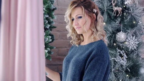 Cute blonde model posing near christmas tree. Stock Footage 84076583