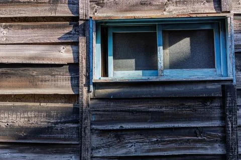 Cute Blue Window Frame Adorns the Weather Wood Siding of Building Stock Photos