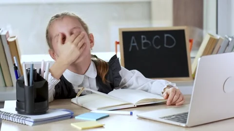 Cute bored school girl using laptop at home. Distance learning course Video stock 274292829