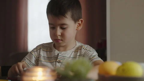 Cute boy 4-5 years old painting easter eggs with felt-tips. The child is busy Stock Footage 249596345