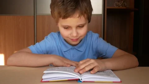 Cute boy 6-7 years old reading a book Stock Footage 149767044