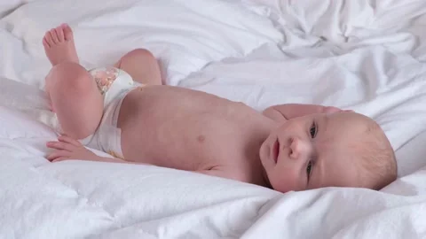 Cute boy 6 months old or half a year old on a light background Stock Footage 235380844