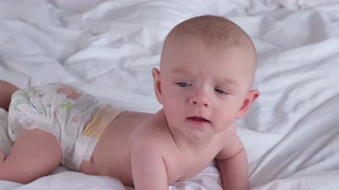 Cute boy 6 months old or half a year old on a light background Stock Footage 235679785