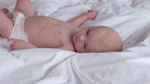 Cute boy 6 months old or half a year old on a light background Stock Footage 236613488