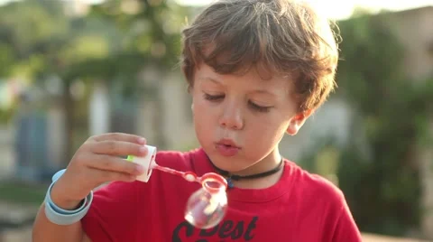 Cute boy blowing soap bubbles Stock-Footage 42421296