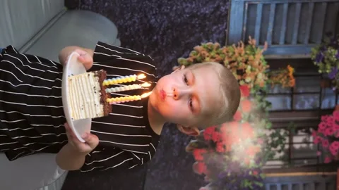 Cute boy blows out the candles on the birthday cake. vertical screen Stock Footage 280152211