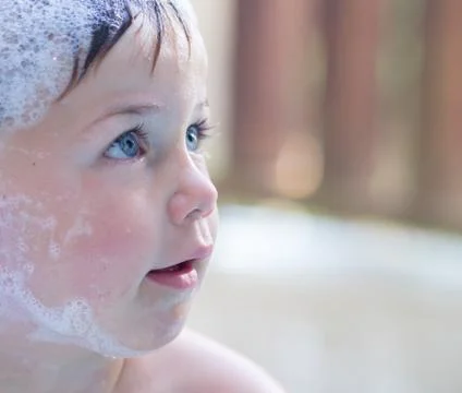 Cute boy in bubble bath Stock Photos