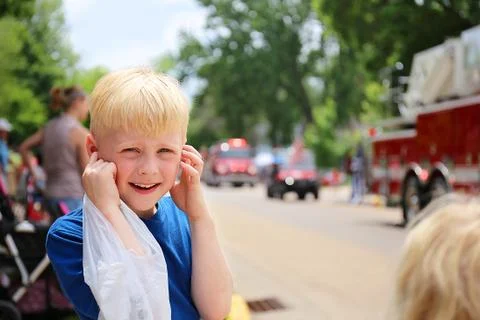 Cute Boy Child at Parade Plugging his Ears from the Loud Fire Truck Sirens Stock Photos