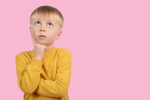 Cute boy child thoughtfully looking up Stock Photos