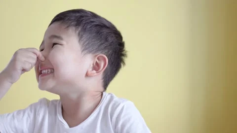 Cute boy close his nose on colour background. Stock Footage 195039488
