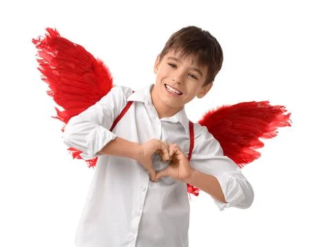 Cute boy with Cupid's wings making heart gesture on white background. Valenti Stock Photos