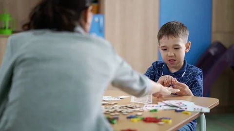 The cute boy is doing the breathing exercise at speech therapy session Stock Footage 93777015