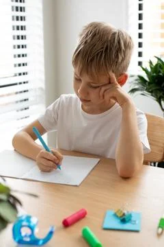 Cute boy doing school homework at home. Distance education. Online education. Foto stock
