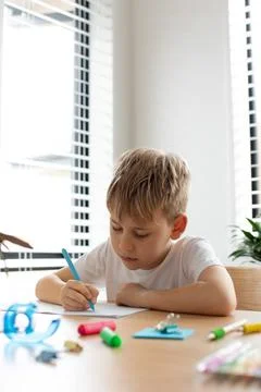 Cute boy doing school homework at home. Distance education. Online education. Foto stock