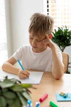 Cute boy doing school homework at home. Distance education. Online education. Foto stock