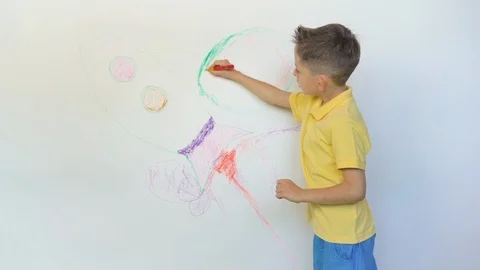 Cute boy drawing rocket on white background Stock Footage 114738254