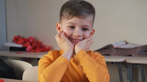 Cute boy dreaming in school during lessons. Child imagination smiling Stock Footage 124907207