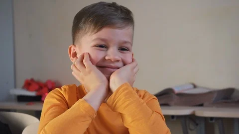 Cute boy dreaming in school during lessons. Child imagination smiling Stock Footage 124908537