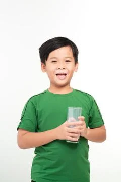 Cute boy drinking milk on light background Stock Photos