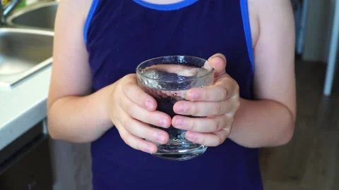 Cute boy drinking water on kitchen Stock Footage 135072430