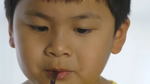 Cute a boy drinking water by straw on white background, Stock-Footage 92322283