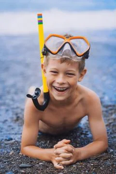 Cute boy driver on the beach Stock Photos